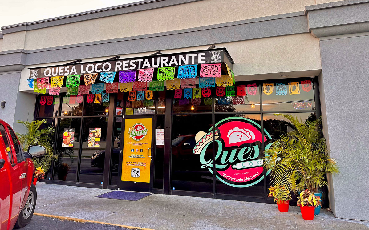 front of building with bright colored quesa loco sign